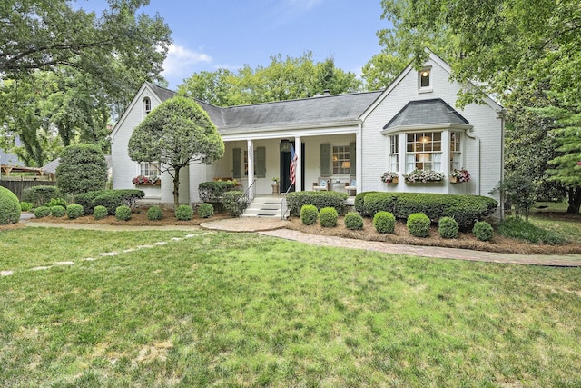 view of front of home with a porch and a front yard