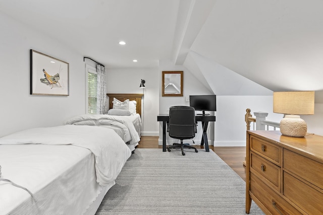 bedroom featuring vaulted ceiling with beams and dark wood-type flooring