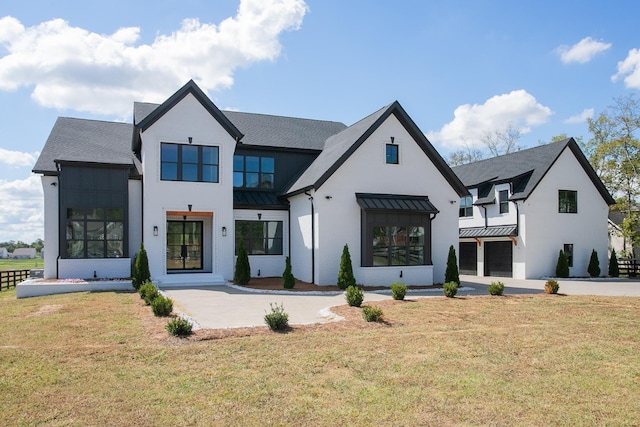 rear view of property with a lawn