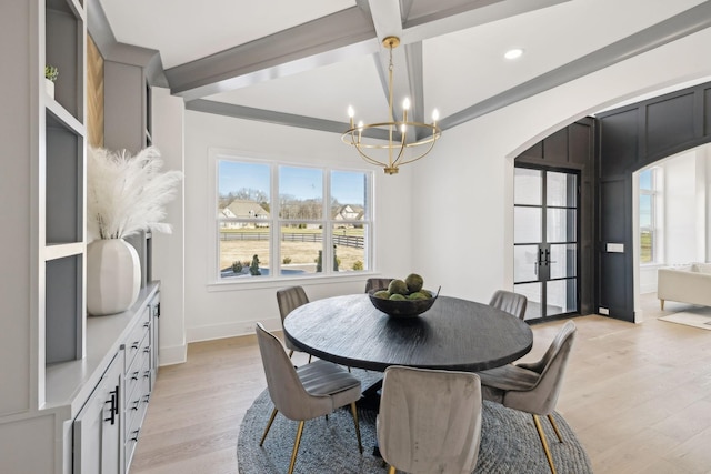 dining space featuring coffered ceiling, a notable chandelier, light hardwood / wood-style flooring, and beamed ceiling