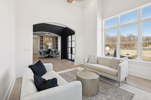 living room featuring a notable chandelier and light hardwood / wood-style floors