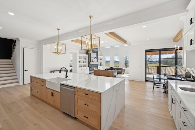 kitchen with sink, dishwasher, white cabinetry, a center island with sink, and beamed ceiling