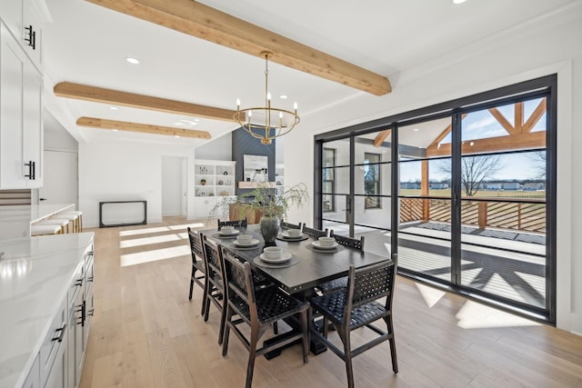 dining room featuring beamed ceiling, an inviting chandelier, and light hardwood / wood-style flooring