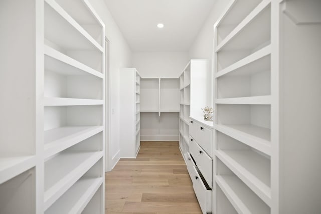 spacious closet with light hardwood / wood-style floors