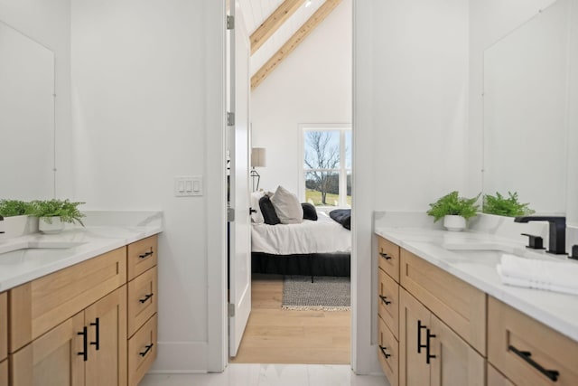 bathroom with vanity, wood-type flooring, and beam ceiling