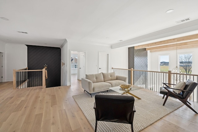 living room featuring ornamental molding and light hardwood / wood-style floors