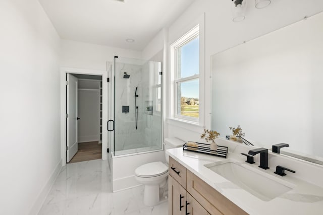 full bathroom featuring vanity, toilet, and combined bath / shower with glass door