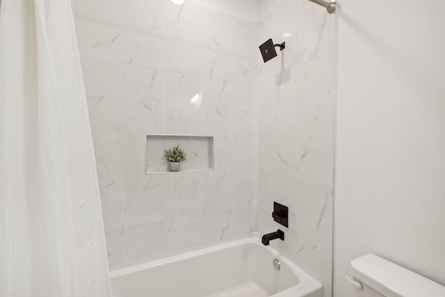 bathroom featuring shower / bath combination with curtain and toilet