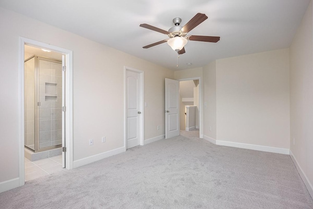 unfurnished bedroom with ensuite bathroom, ceiling fan, and light colored carpet