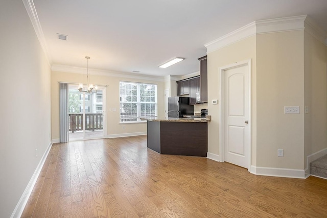 kitchen featuring black fridge, dark brown cabinetry, and crown molding