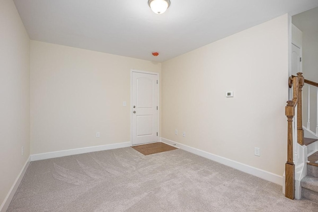 unfurnished room featuring light colored carpet