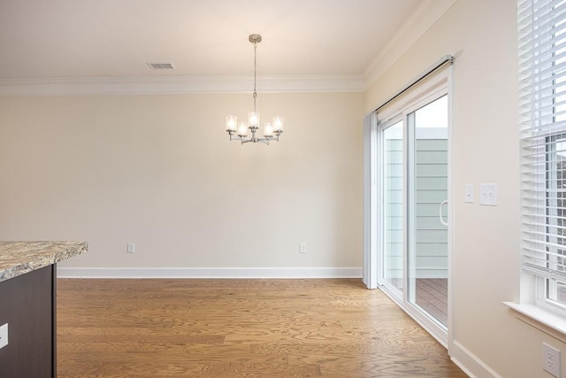 unfurnished dining area featuring wood-type flooring, a chandelier, and ornamental molding