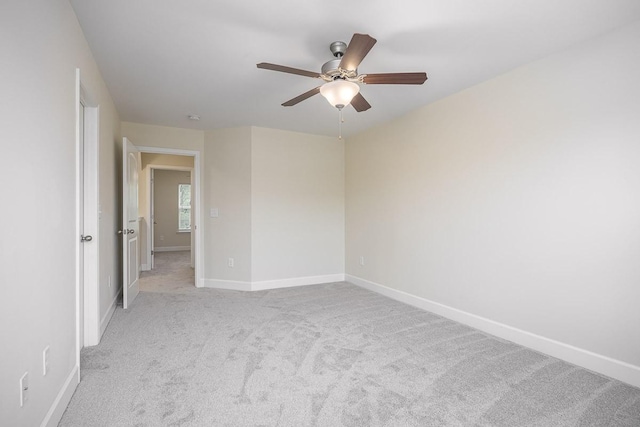 unfurnished room with ceiling fan and light carpet