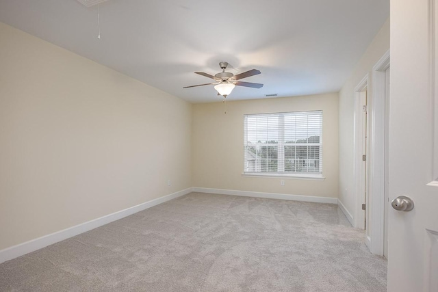 carpeted empty room featuring ceiling fan