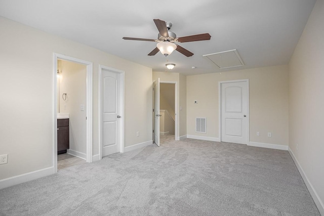 unfurnished bedroom with connected bathroom, light colored carpet, and ceiling fan