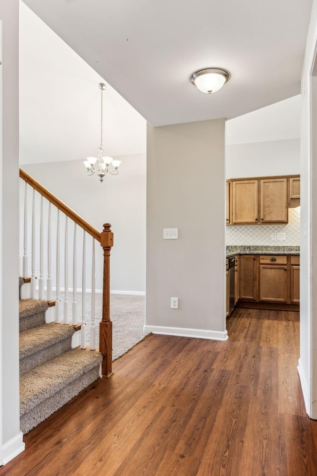 2016 Shamrock Dr, Spring Hill, TN 37174 - kitchen with dark wood-style flooring, a chandelier, brown cabinets, and decorative backsplash