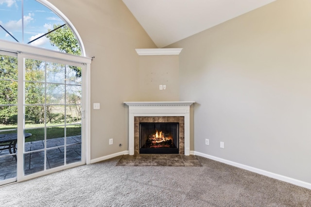 2016 Shamrock Dr, Spring Hill, TN 37174 - unfurnished living room featuring a tiled fireplace, carpet floors, and high vaulted ceiling