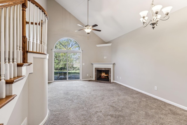 2016 Shamrock Dr, Spring Hill, TN 37174 - unfurnished living room featuring carpet floors, high vaulted ceiling, a tiled fireplace, a ceiling fan, and a chandelier