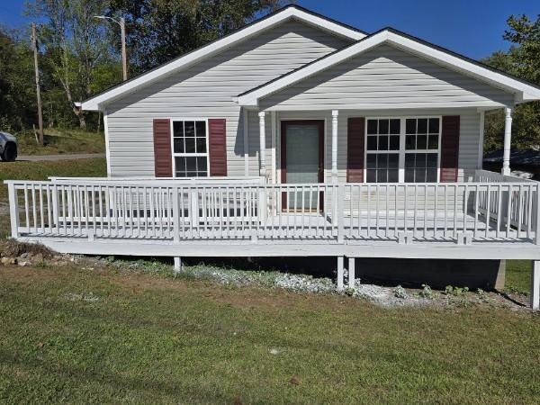 back of property featuring a lawn