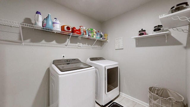 clothes washing area featuring light tile patterned floors and independent washer and dryer