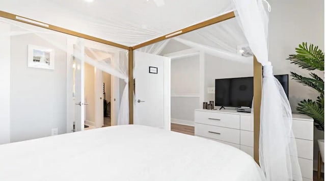 bedroom featuring lofted ceiling and wood finished floors