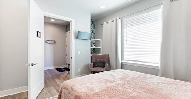 bedroom featuring wood finished floors and baseboards