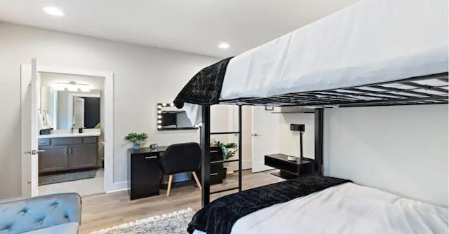 bedroom with recessed lighting, ensuite bathroom, and light wood-style floors