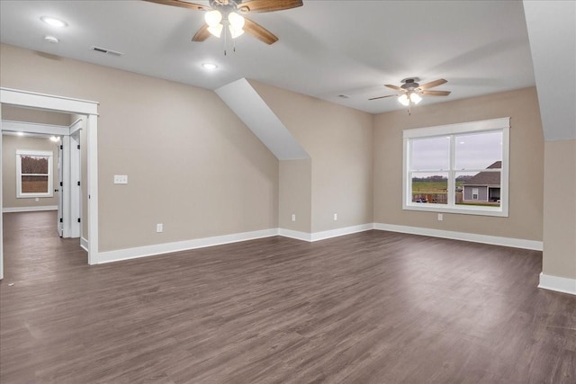 bonus room with ceiling fan and dark wood-type flooring