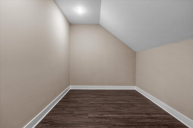 bonus room with dark hardwood / wood-style floors and lofted ceiling