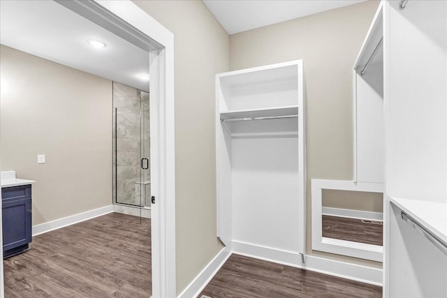 bathroom with vanity, wood-type flooring, and walk in shower