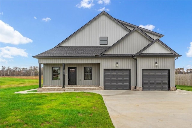 modern inspired farmhouse with a front yard, a garage, and covered porch