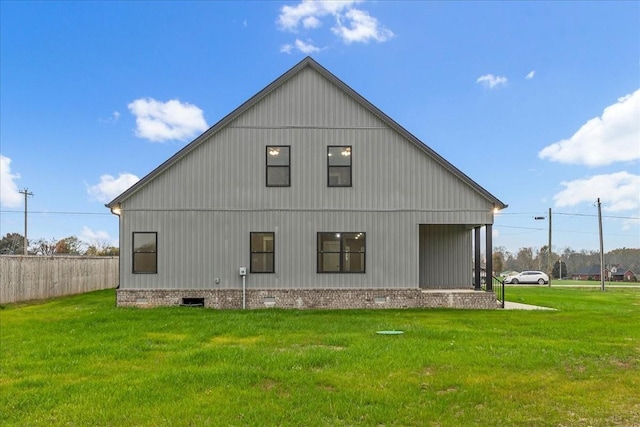 rear view of property featuring a yard