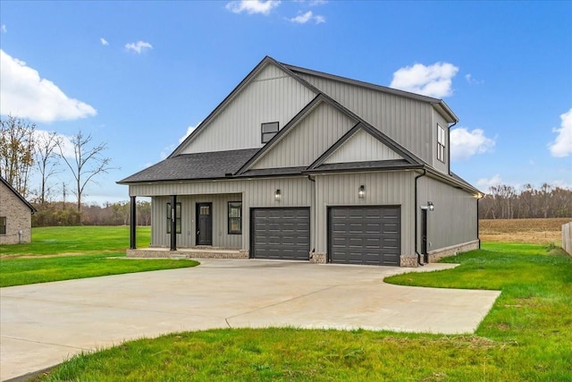 modern inspired farmhouse featuring covered porch, a garage, and a front lawn