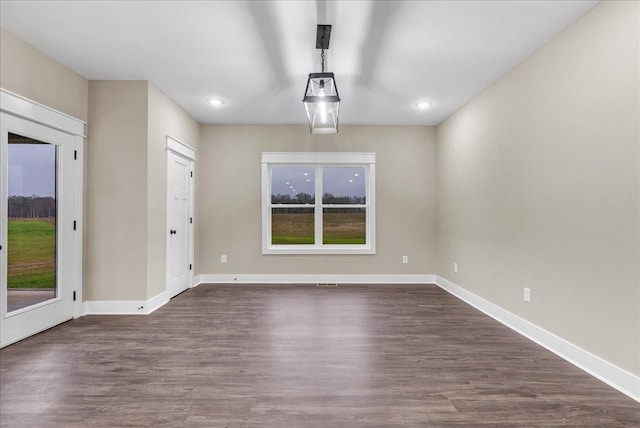 unfurnished dining area featuring dark hardwood / wood-style floors