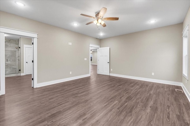 spare room with ceiling fan and dark hardwood / wood-style flooring