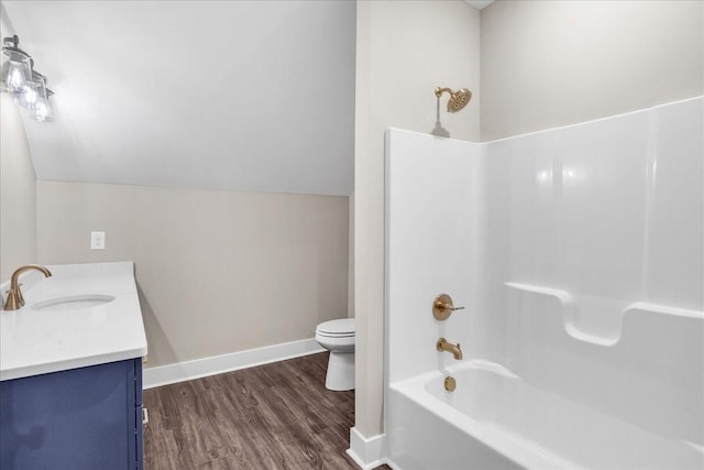 full bathroom with vanity, toilet, tub / shower combination, and vaulted ceiling