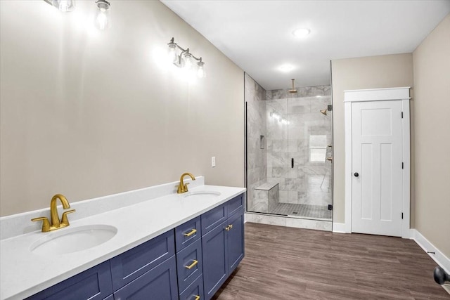 bathroom featuring hardwood / wood-style flooring, vanity, and a shower with door