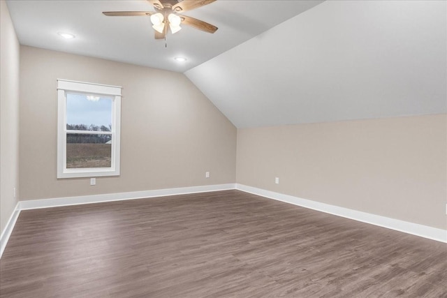 bonus room with ceiling fan, dark wood-type flooring, and vaulted ceiling