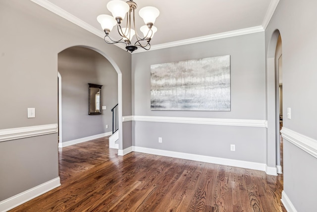 unfurnished dining area with dark hardwood / wood-style floors, ornamental molding, and a chandelier