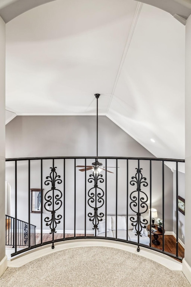 interior space featuring carpet flooring, lofted ceiling, and crown molding