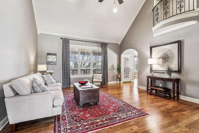 living room featuring crown molding, high vaulted ceiling, hardwood / wood-style flooring, and ceiling fan