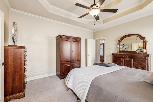 bedroom with a raised ceiling, ceiling fan, light colored carpet, and ornamental molding