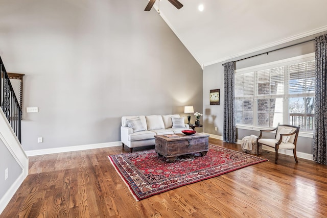 living room featuring hardwood / wood-style floors, ceiling fan, crown molding, and high vaulted ceiling