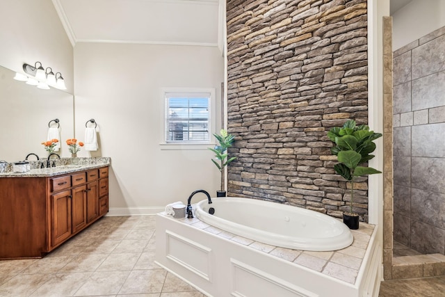 bathroom featuring a bathing tub, tile patterned flooring, vanity, and ornamental molding