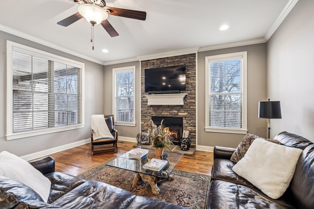 living room featuring a fireplace, hardwood / wood-style flooring, plenty of natural light, and ceiling fan