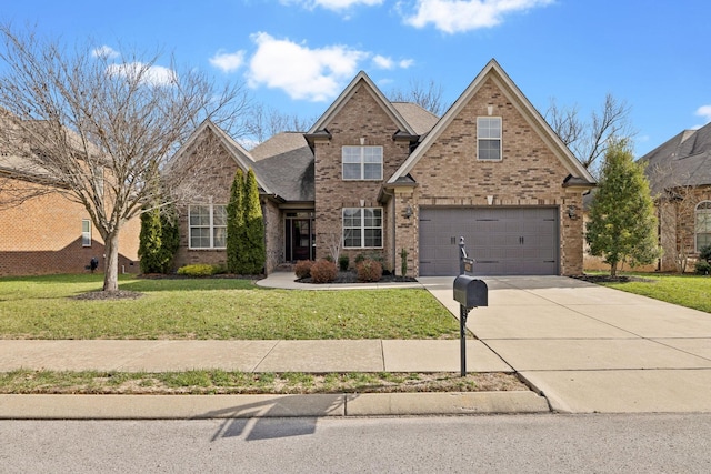 view of front of home with a front lawn and a garage