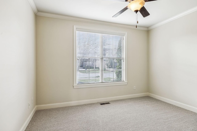 empty room featuring carpet, a healthy amount of sunlight, and ornamental molding