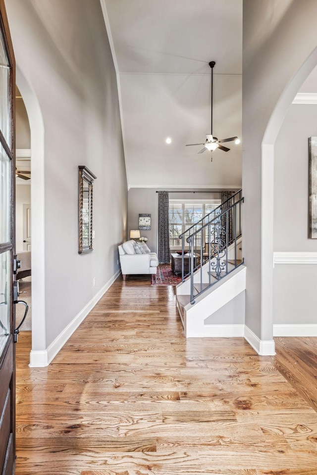 entrance foyer with ceiling fan, light hardwood / wood-style flooring, and ornamental molding