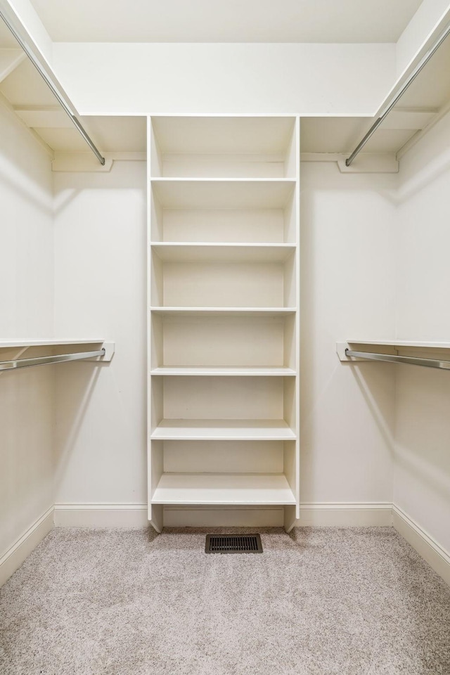 walk in closet with carpet flooring