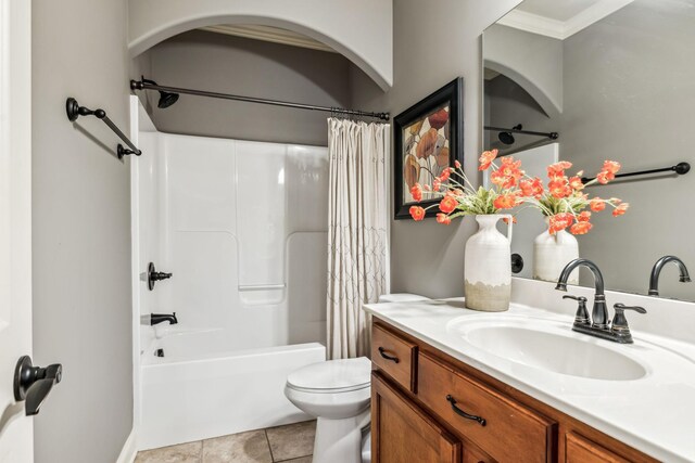 full bathroom featuring vanity, tile patterned floors, crown molding, toilet, and shower / tub combo